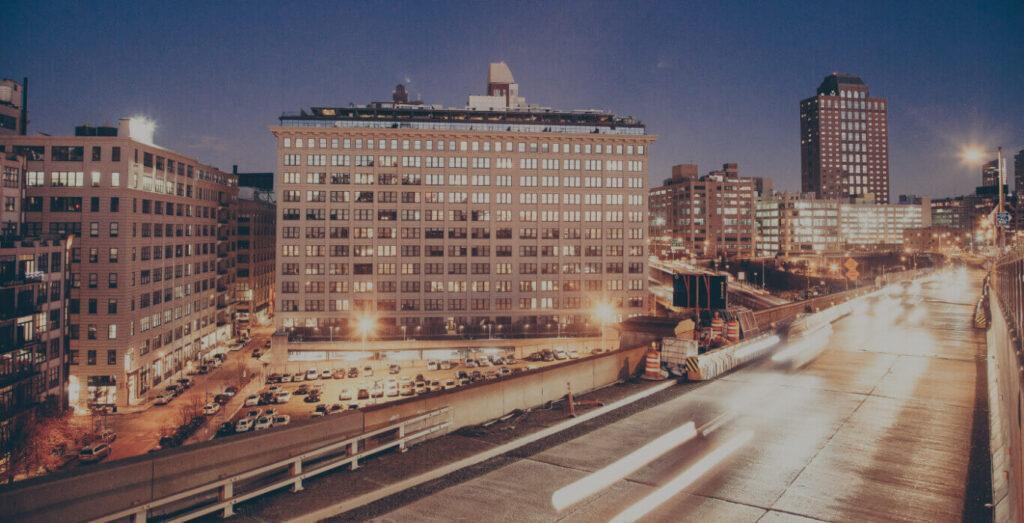 City skyline with cars rushing across freeway