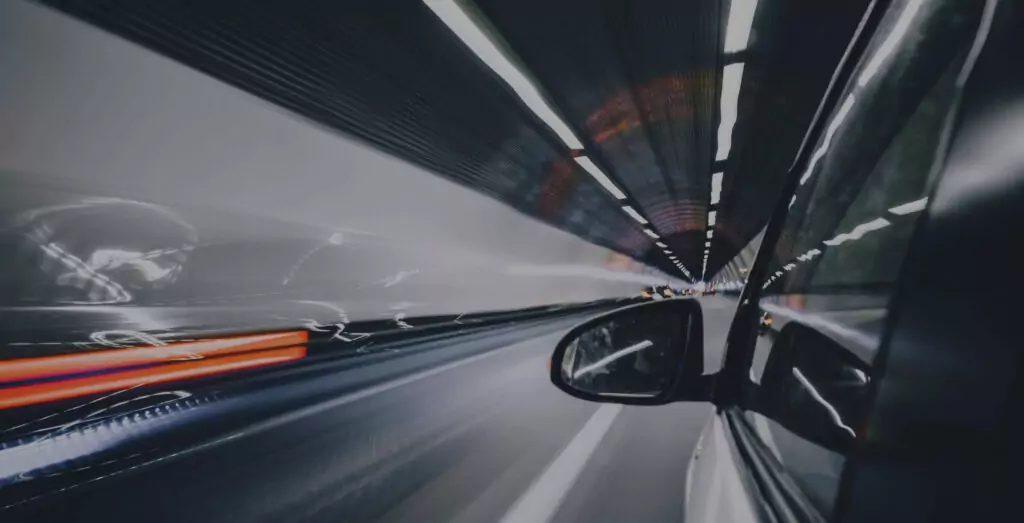 Car driving through tunnel