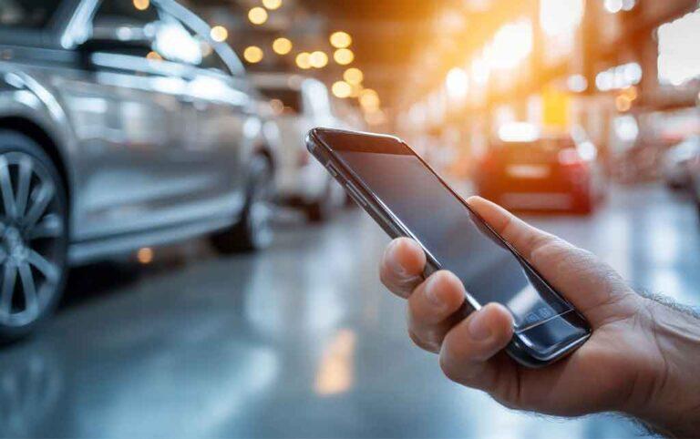 A driver using a smartphone to interact with an online parking reservation system at a modern parking facility.